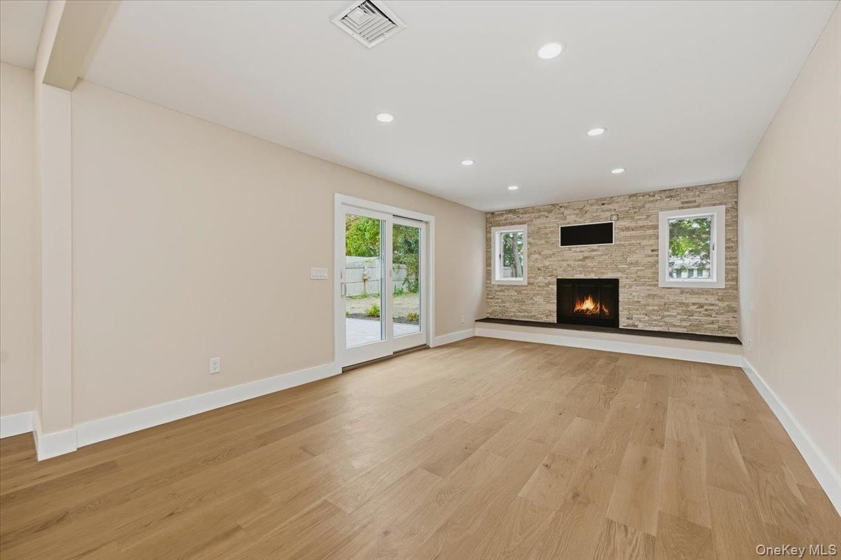 Empty room, Fireplace, Interior, Recessed Lighting, Stone Walls, Wood Texture Flooring