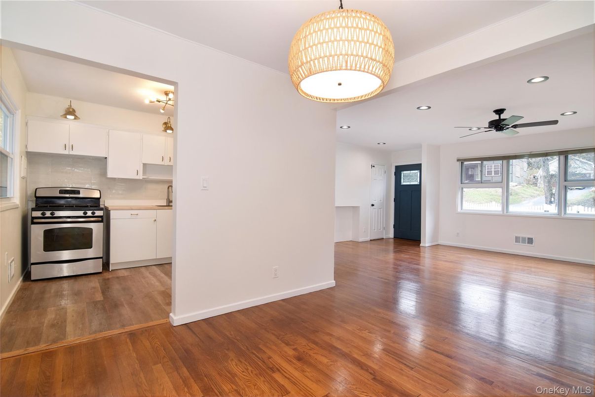 Empty room, Interior, Kitchen, Recessed Lighting, Stainless Steel Appliances, Wood Texture Flooring