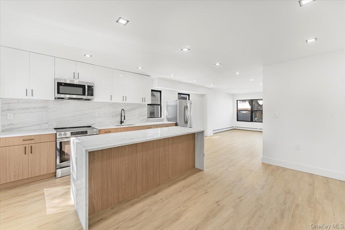 Interior, Kitchen, Marble Walls, Recessed Lighting, Stainless Steel Appliances, Wood Texture Flooring