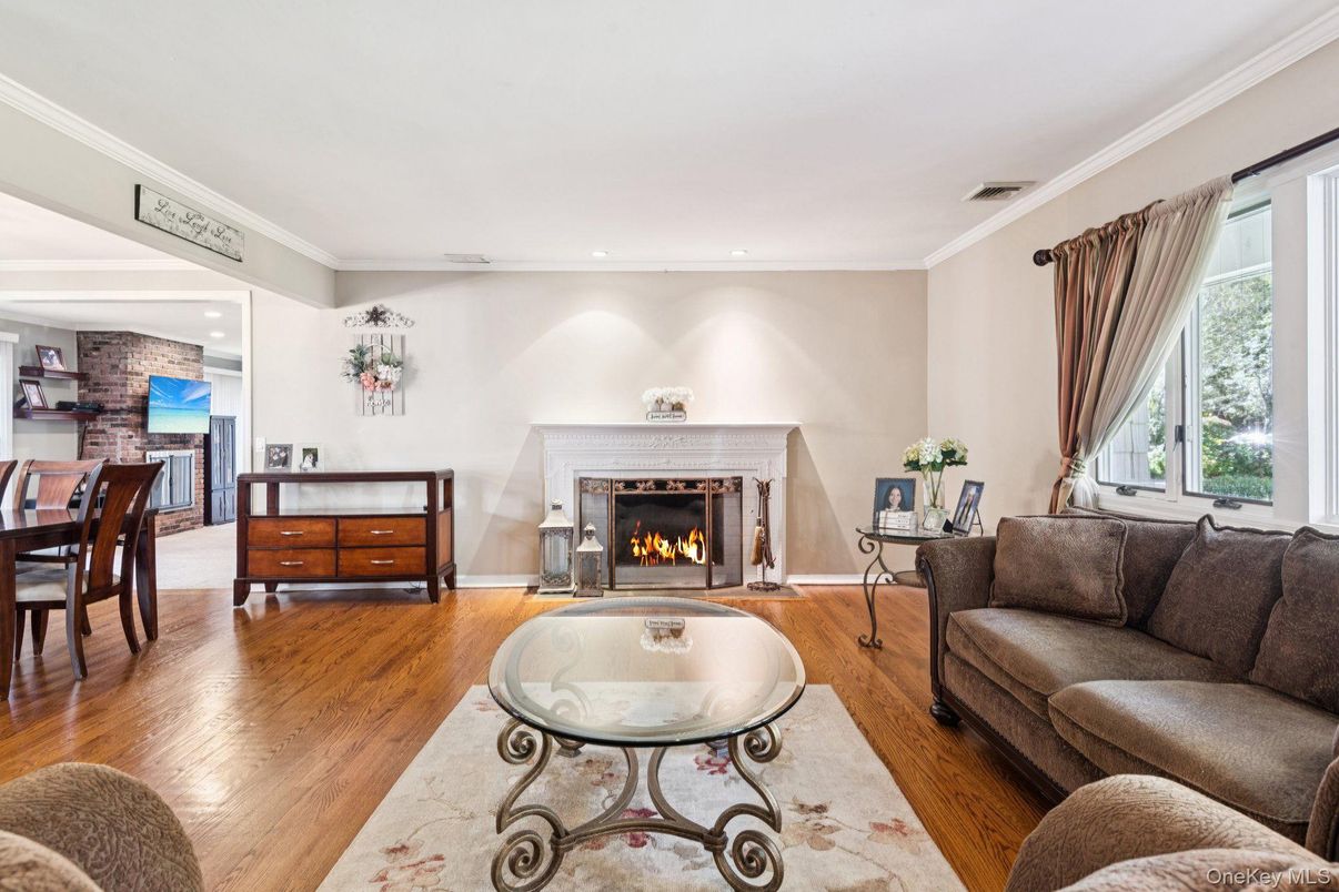 Dining room, Fireplace, Interior, Living room, Recessed Lighting, Stone Walls, Wood Texture Flooring