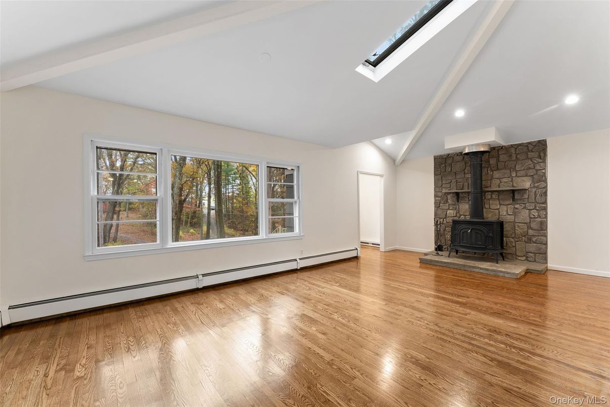 Empty room, Fireplace, Interior, Recessed Lighting, Stone Walls, Wood Texture Flooring