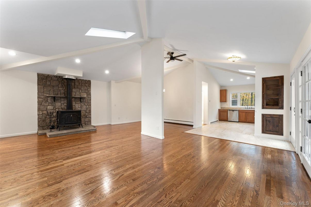 Empty room, Fireplace, Interior, Recessed Lighting, Stone Walls, Wood Texture Flooring