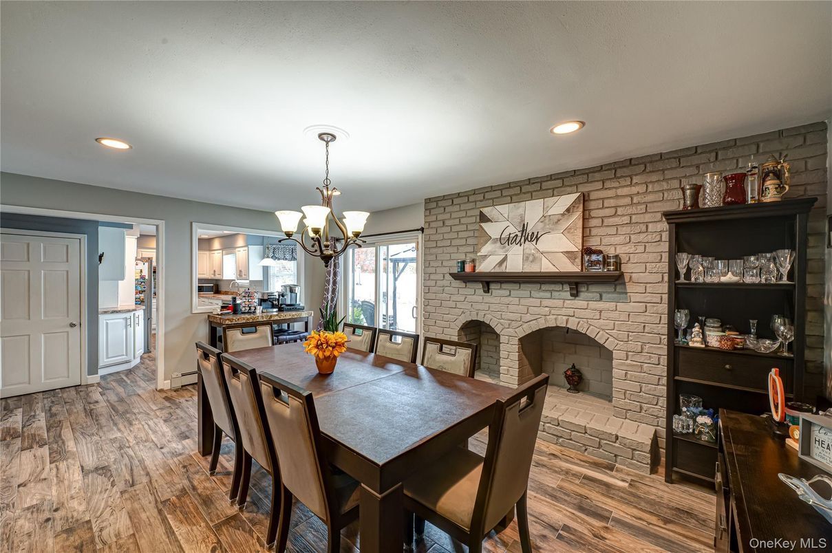 Chandelier, Dining room, Fireplace, Interior, Kitchen, Recessed Lighting, Stone Walls, Wood Texture Flooring