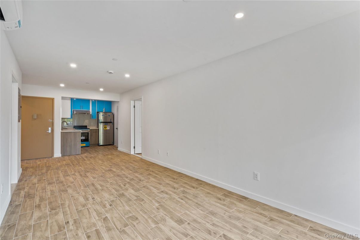 Empty room, Interior, Kitchen, Recessed Lighting, Stainless Steel Appliances, Wood Texture Flooring