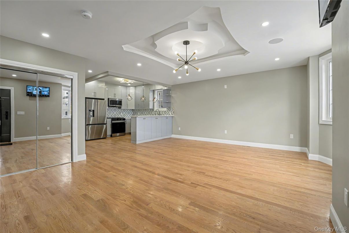 Empty room, Interior, Kitchen, Pendant Lights, Recessed Lighting, Stainless Steel Appliances, Wood Texture Flooring