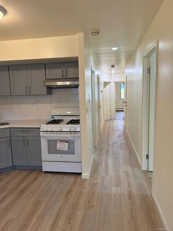 Interior, Kitchen, Marble Walls, Recessed Lighting, Stainless Steel Appliances, Wood Texture Flooring