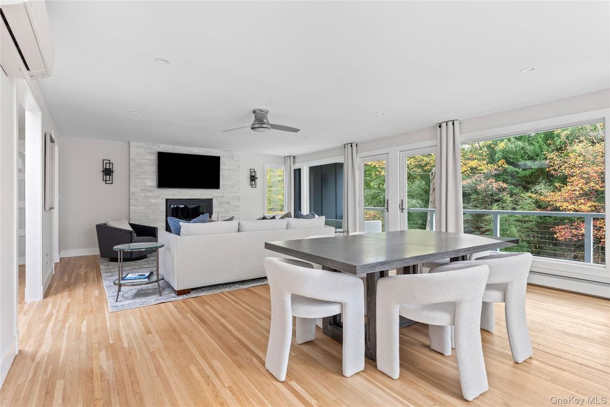 Dining room, Fireplace, Interior, Living room, Recessed Lighting, Stone Walls, Wood Texture Flooring