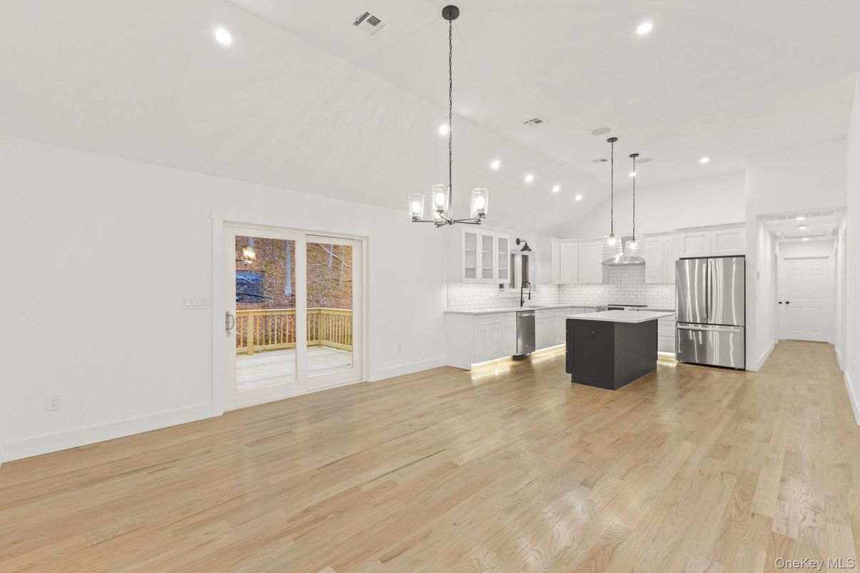 Empty room, Interior, Kitchen, Pendant Lights, Recessed Lighting, Stainless Steel Appliances, Wood Texture Flooring