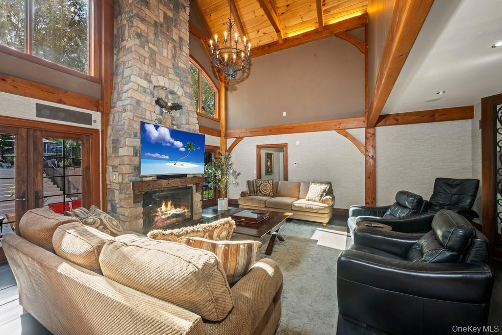 Chandelier, Fireplace, Interior, Living room, Recessed Lighting, Stone Walls, Wooden Beams, Wooden Ceilings