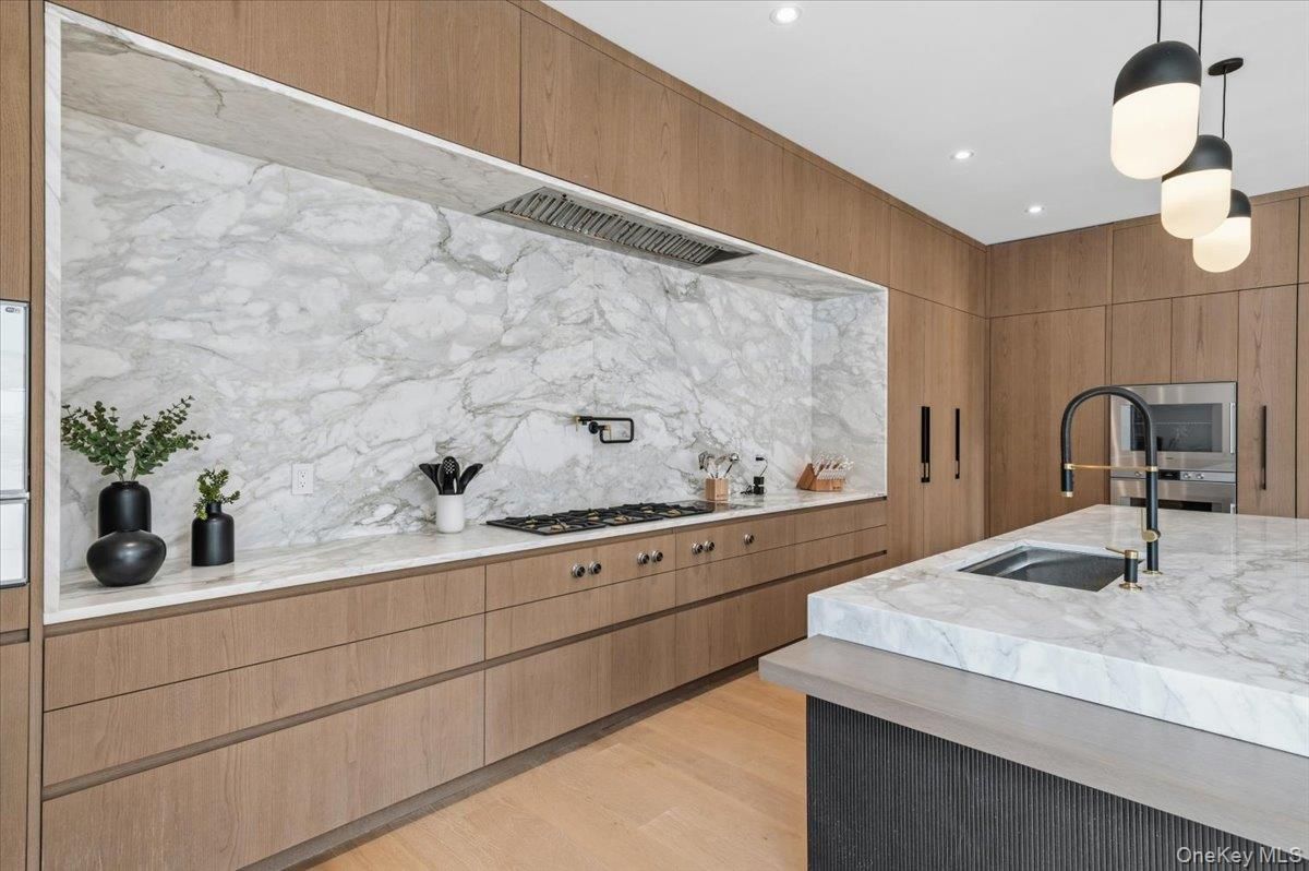 Interior, Kitchen, Marble Walls, Pendant Lights, Recessed Lighting, Stainless Steel Appliances, Wood Texture Flooring