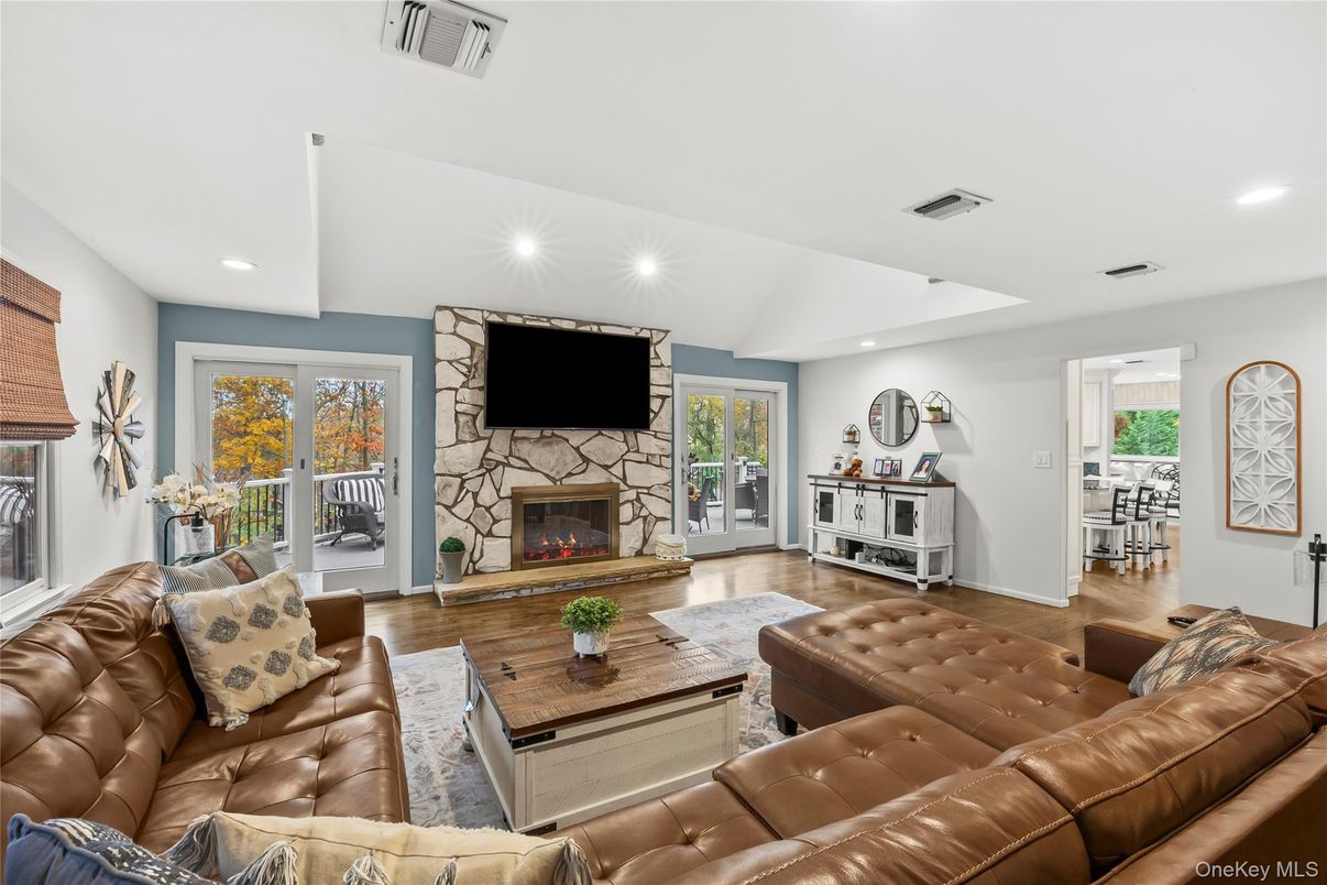 Fireplace, Interior, Living room, Recessed Lighting, Stone Walls, Wood Texture Flooring