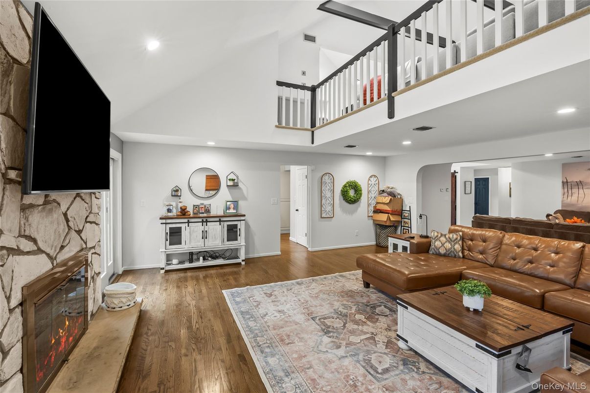 Fireplace, Interior, Living room, Recessed Lighting, Stone Walls, Wood Texture Flooring