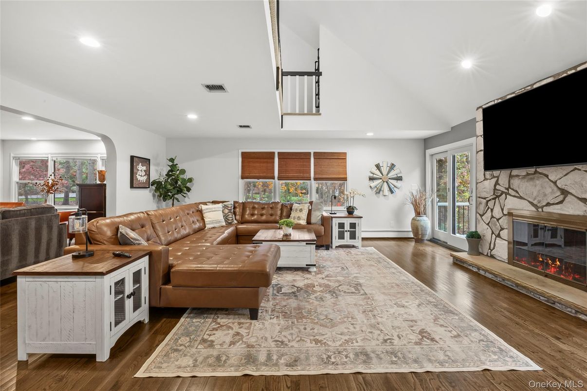 Fireplace, Interior, Living room, Recessed Lighting, Stone Walls, Wood Texture Flooring