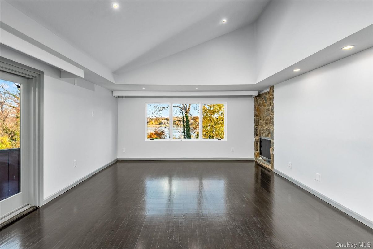 Empty room, Fireplace, Interior, Recessed Lighting, Stone Walls, Wood Texture Flooring