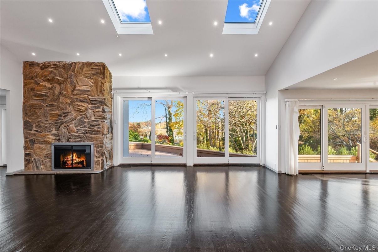 Empty room, Fireplace, Glass Ceilings, Interior, Recessed Lighting, Sun Room, Wood Texture Flooring