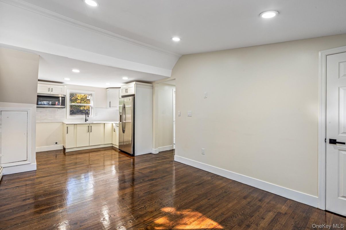 Empty room, Interior, Kitchen, Recessed Lighting, Stainless Steel Appliances, Wood Texture Flooring