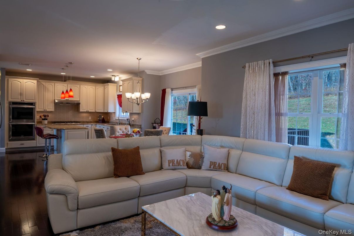 Chandelier, Dining room, Interior, Kitchen, Living room, Pendant Lights, Recessed Lighting, Stainless Steel Appliances, Wood Texture Flooring