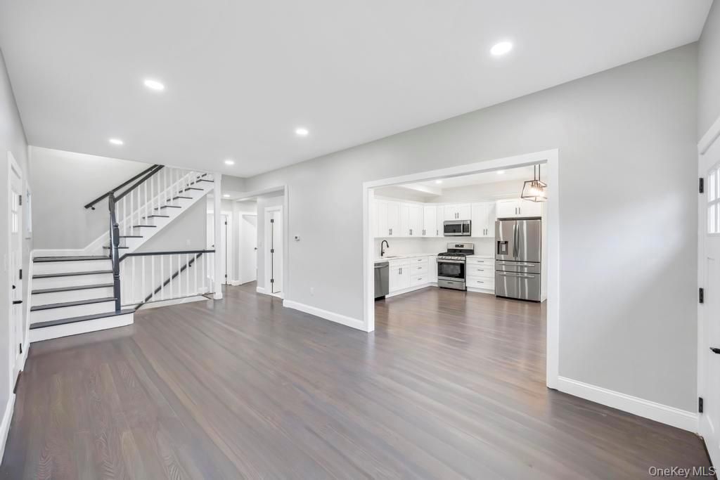 Empty room, Interior, Kitchen, Pendant Lights, Recessed Lighting, Stainless Steel Appliances, Wood Texture Flooring