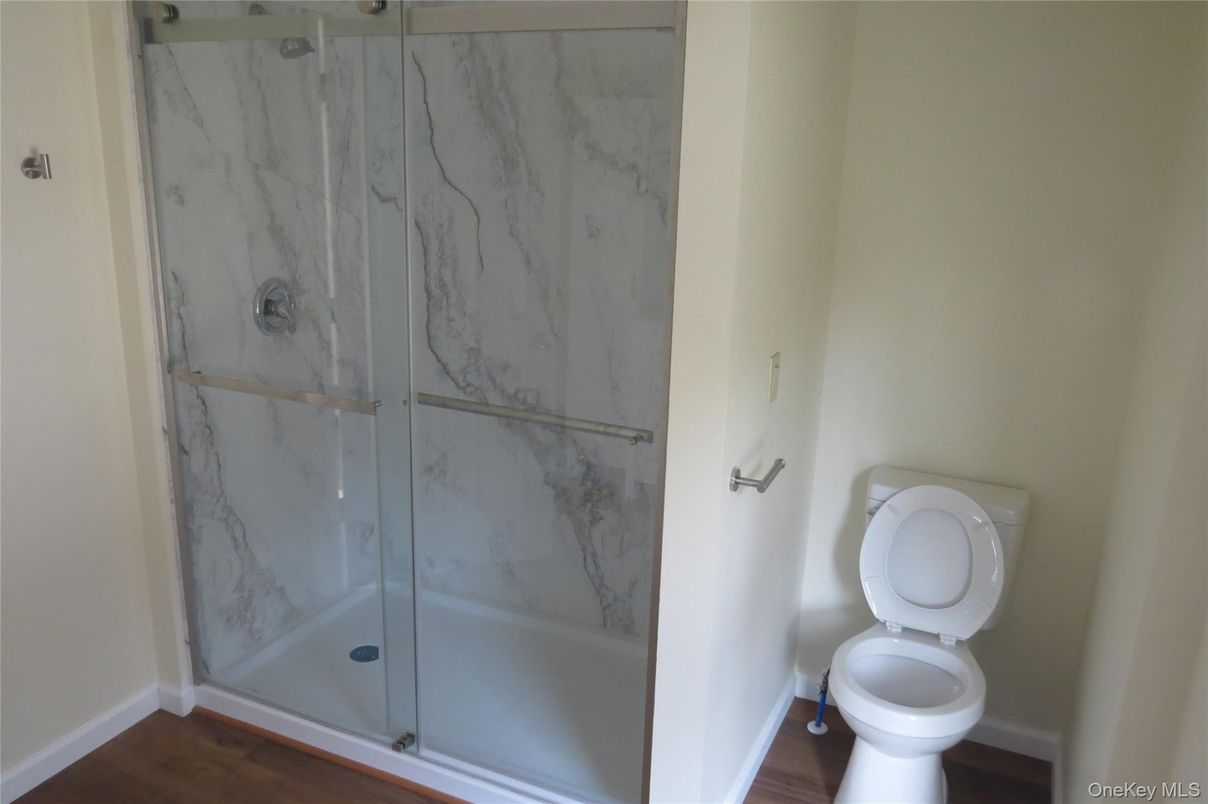 Bathroom, Glass Shower, Interior, Marble Walls, Wood Texture Flooring