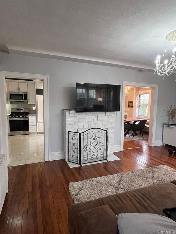 Chandelier, Dining room, Fireplace, Interior, Kitchen, Living room, Stainless Steel Appliances, Wood Texture Flooring