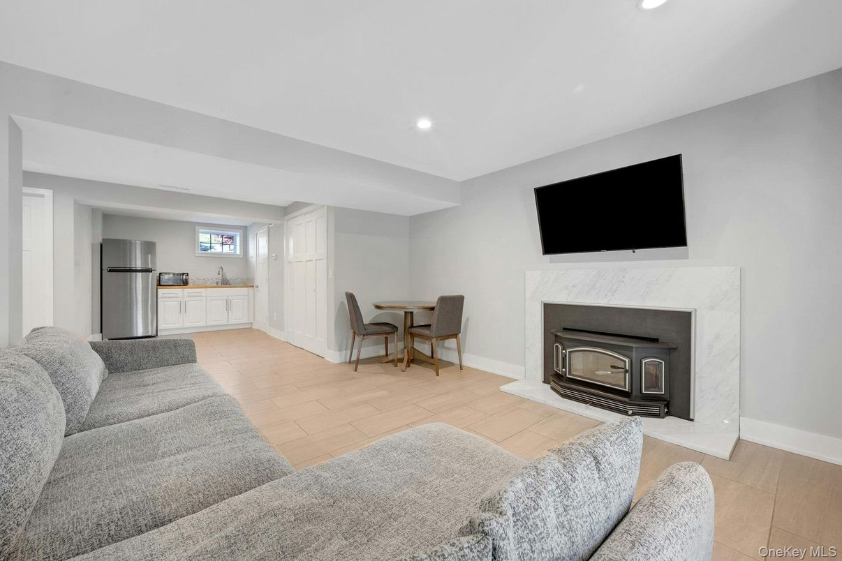 Dining room, Fireplace, Interior, Kitchen, Living room, Recessed Lighting, Stainless Steel Appliances, Wood Texture Flooring