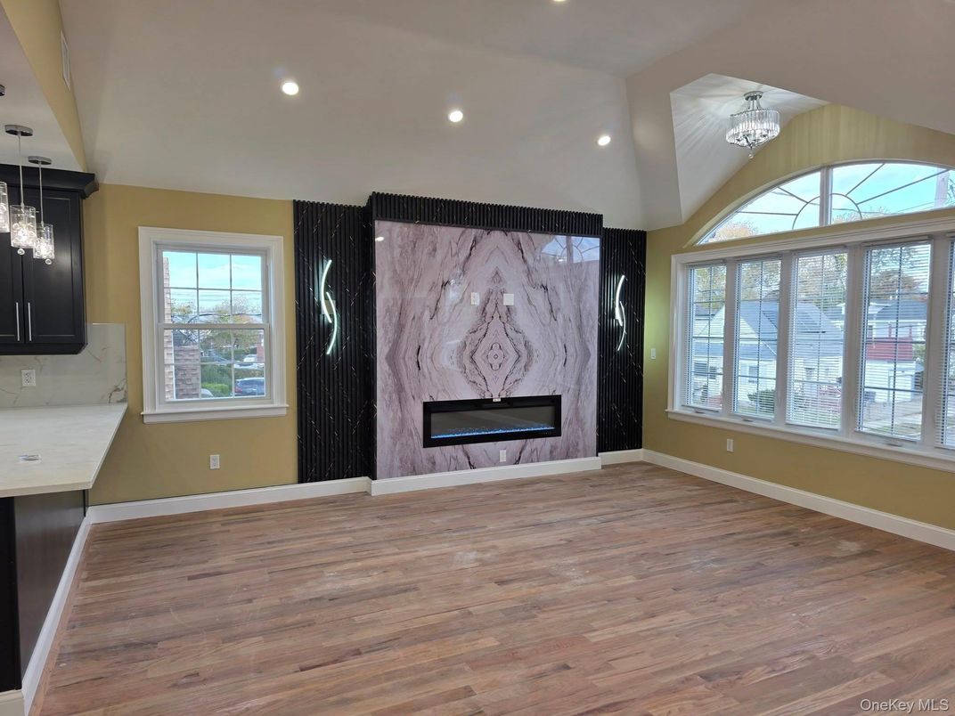 Chandelier, Fireplace, Interior, Marble Walls, Pendant Lights, Recessed Lighting, Wood Texture Flooring