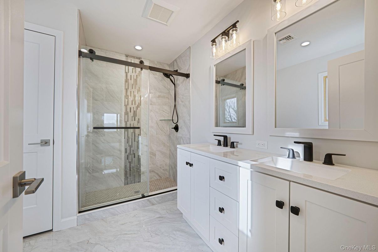 Bathroom, Dual Sink Vanities, Glass Shower, Interior, Marble, Marble Walls, Recessed Lighting