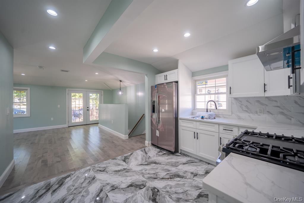 Interior, Kitchen, Marble, Marble Walls, Recessed Lighting, Stainless Steel Appliances, Wood Texture Flooring