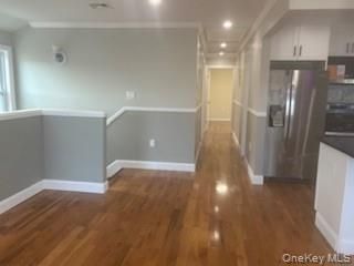 Empty room, Interior, Kitchen, Recessed Lighting, Stainless Steel Appliances, Wood Texture Flooring