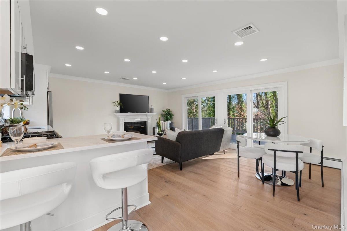 Dining room, Fireplace, Interior, Living room, Recessed Lighting, Wood Texture Flooring