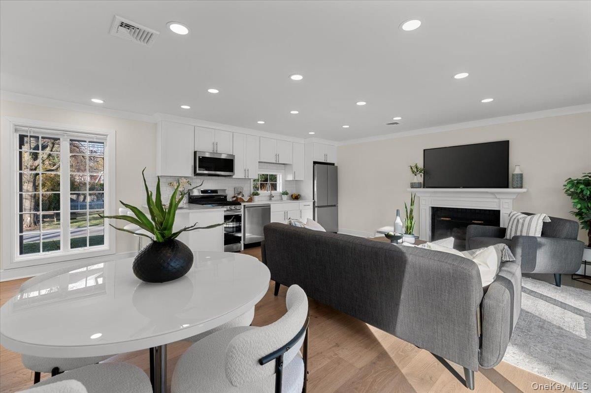 Dining room, Fireplace, Interior, Kitchen, Living room, Recessed Lighting, Stainless Steel Appliances, Wood Texture Flooring