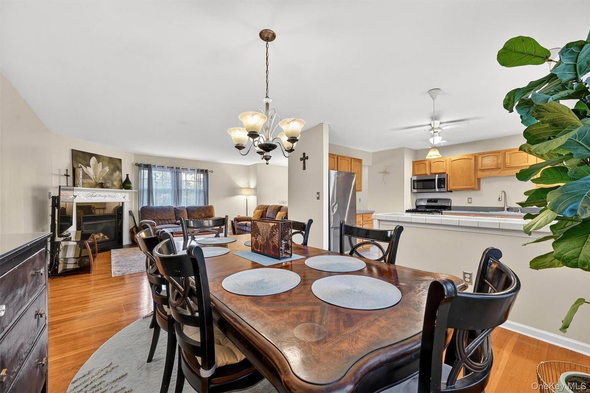 Chandelier, Dining room, Fireplace, Interior, Kitchen, Living room, Stainless Steel Appliances, Wood Texture Flooring