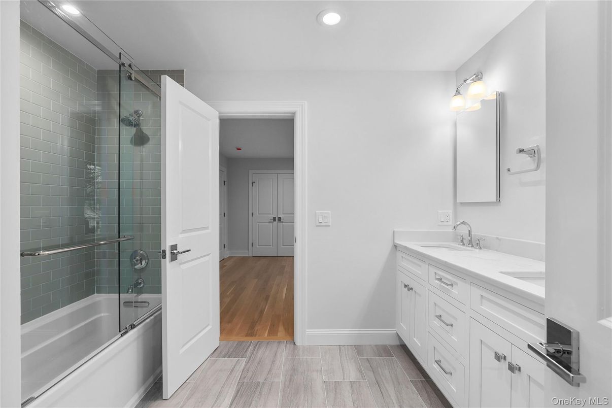 Bathroom, Dual Sink Vanities, Glass Shower, Interior, Recessed Lighting, Wood Texture Flooring
