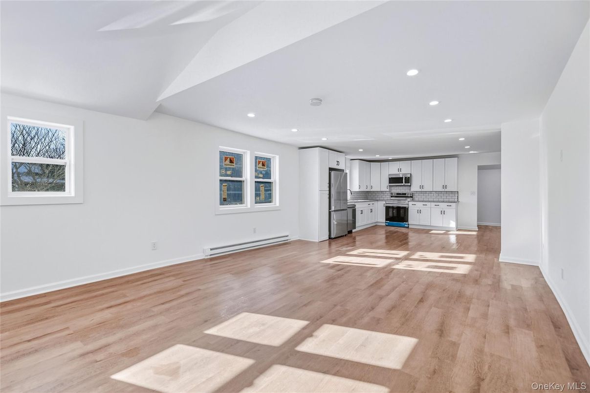 Empty room, Interior, Kitchen, Recessed Lighting, Stainless Steel Appliances, Wood Texture Flooring