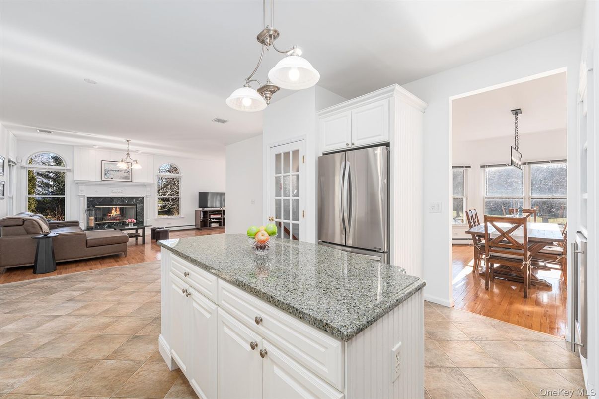 Dining room, Fireplace, Interior, Kitchen, Living room, Pendant Lights, Stainless Steel Appliances, Wood Texture Flooring