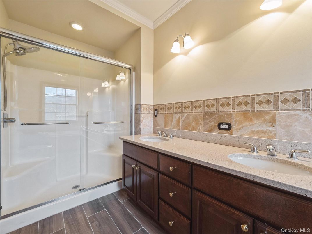 Bathroom, Dual Sink Vanities, Glass Shower, Interior, Recessed Lighting, Wood Texture Flooring
