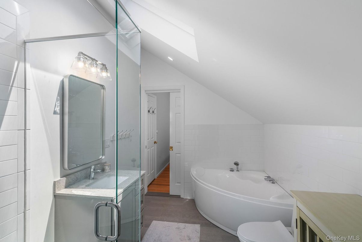 Bathroom, Dual Sink Vanities, Free Standing Baths, Glass Shower, Interior, Recessed Lighting, Wood Texture Flooring