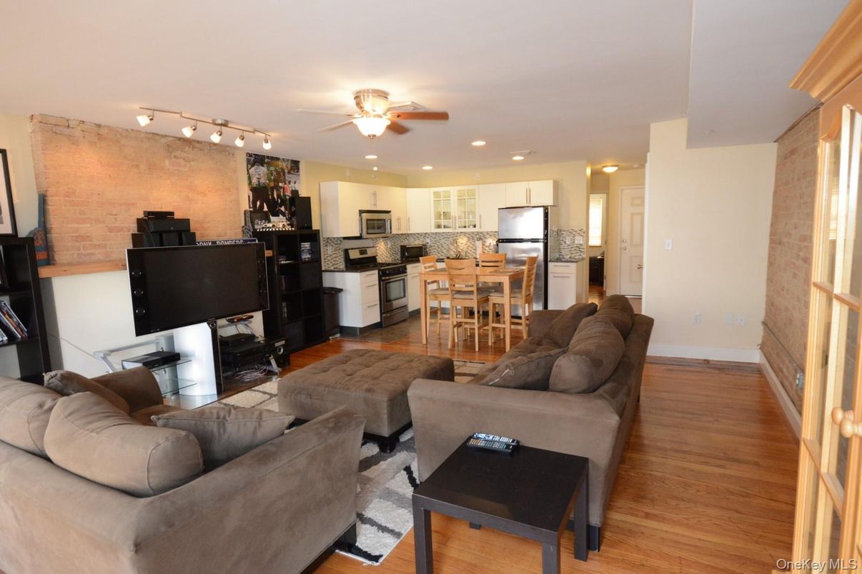 Dining room, Interior, Kitchen, Living room, Recessed Lighting, Stainless Steel Appliances, Stone Walls, Wood Texture Flooring