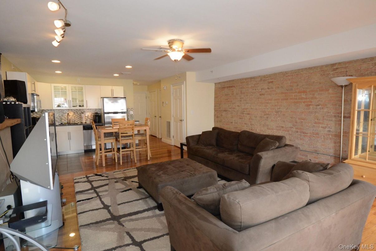 Dining room, Interior, Kitchen, Living room, Recessed Lighting, Stainless Steel Appliances, Stone Walls, Wood Texture Flooring