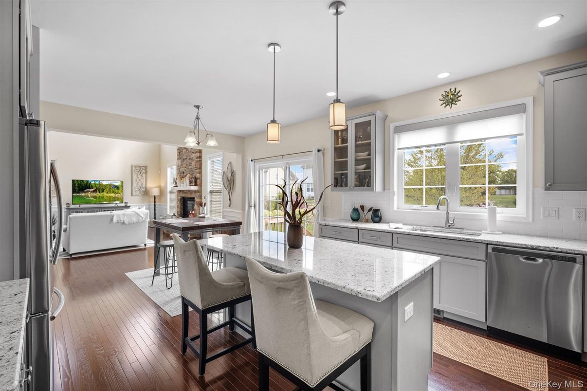 Dining room, Fireplace, Interior, Kitchen, Living room, Pendant Lights, Recessed Lighting, Stainless Steel Appliances, Wood Texture Flooring