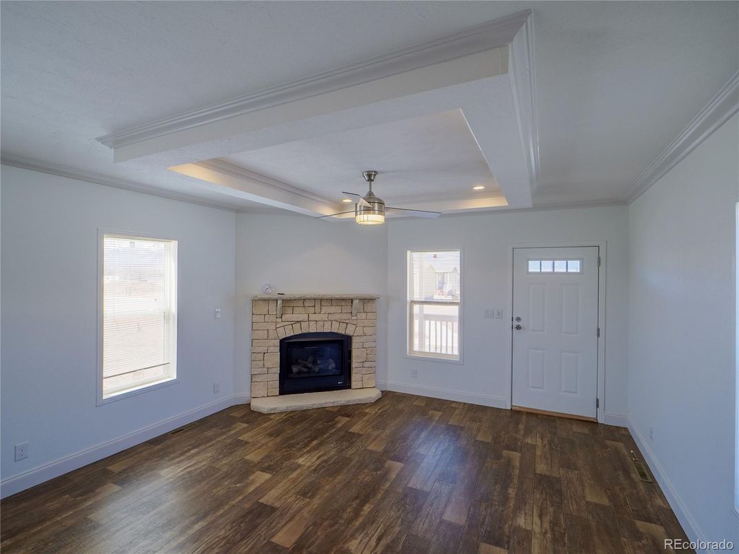 Empty room, Fireplace, Interior, Recessed Lighting, Stone Walls, Wood Texture Flooring