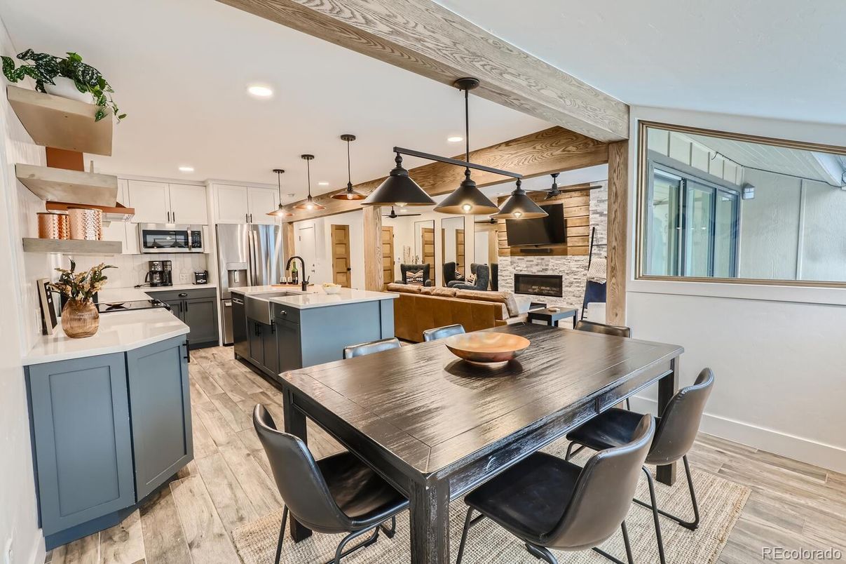 Fireplace, Interior, Kitchen, Pendant Lights, Recessed Lighting, Stainless Steel Appliances, Stone Walls, Wooden Beams, Wood Texture Flooring