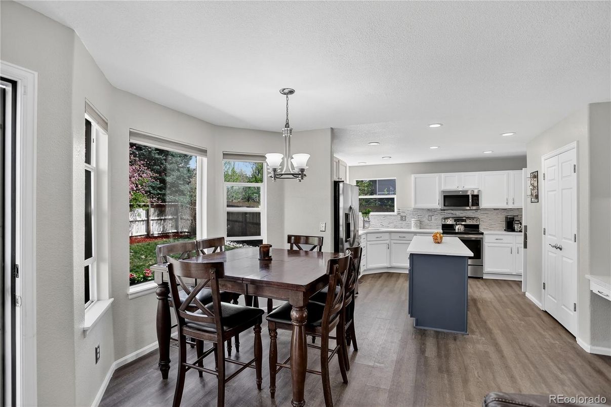 Chandelier, Dining room, Interior, Kitchen, Pendant Lights, Recessed Lighting, Stainless Steel Appliances, Wood Texture Flooring