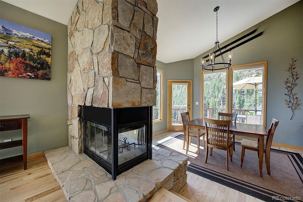 Dining room, Fireplace, Interior, Pendant Lights, Stone Walls, Wood Texture Flooring