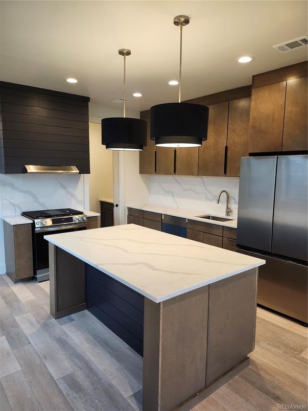 Interior, Kitchen, Marble Walls, Pendant Lights, Recessed Lighting, Stainless Steel Appliances, Wood Texture Flooring
