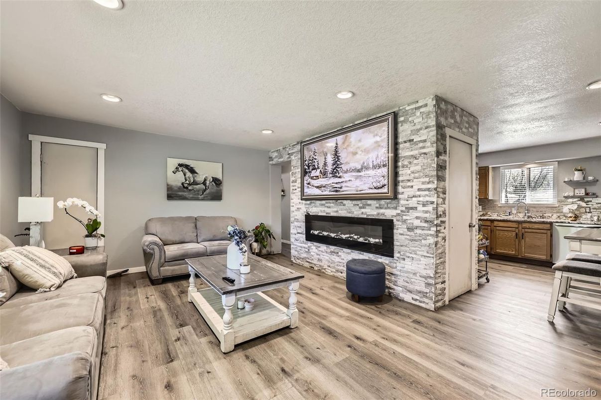 Fireplace, Interior, Living room, Recessed Lighting, Stone Walls, Wood Texture Flooring