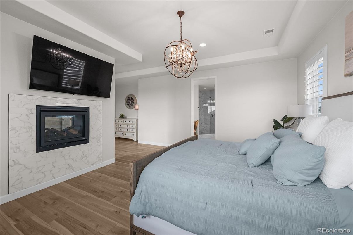 Bedroom, Chandelier, Fireplace, Interior, Pendant Lights, Recessed Lighting, Wood Texture Flooring