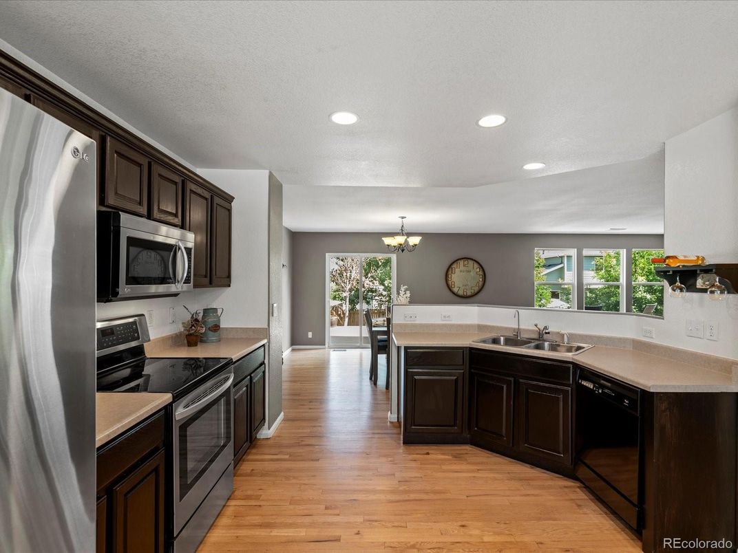 Chandelier, Dining room, Interior, Kitchen, Recessed Lighting, Stainless Steel Appliances, Wood Texture Flooring