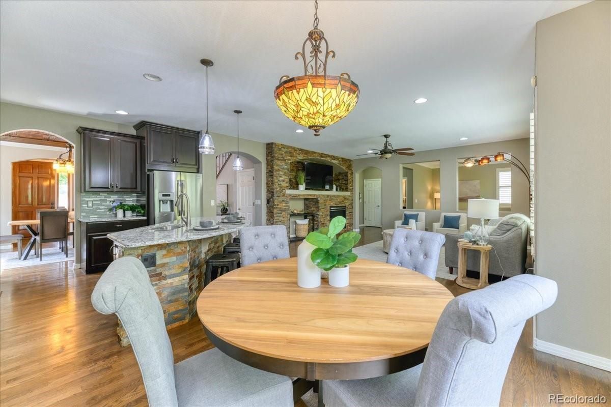 Dining room, Fireplace, Interior, Kitchen, Pendant Lights, Recessed Lighting, Stainless Steel Appliances, Stone Walls, Wood Texture Flooring