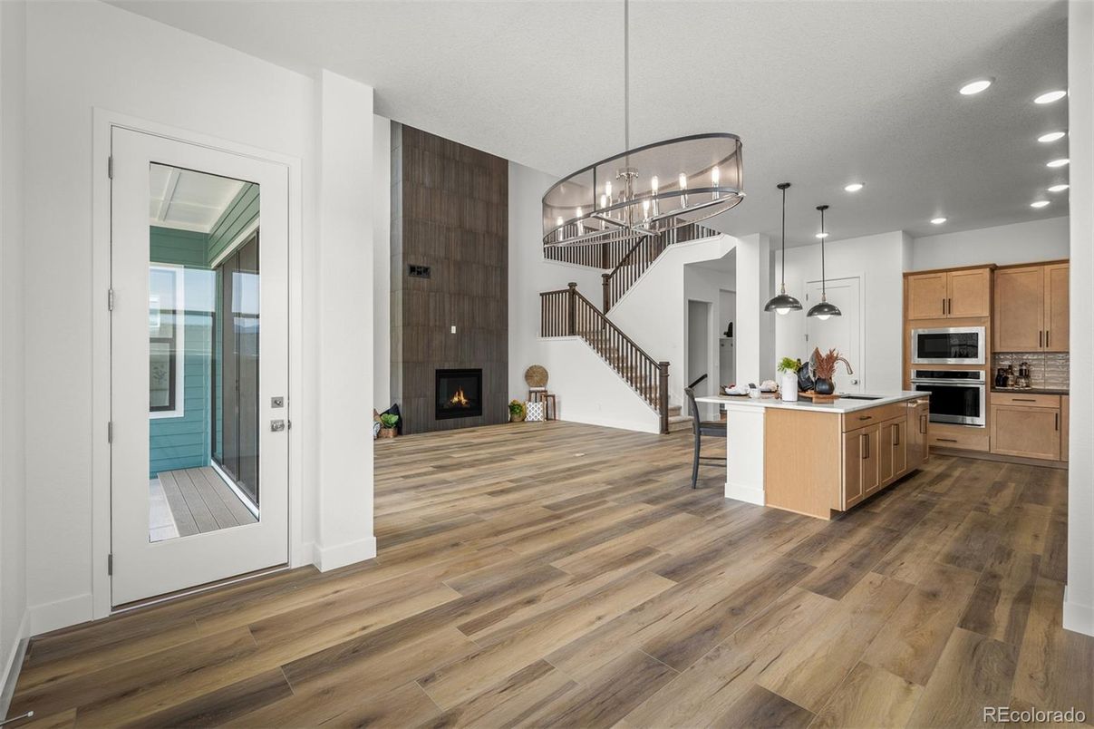 Chandelier, Fireplace, Interior, Kitchen, Pendant Lights, Recessed Lighting, Stainless Steel Appliances, Wood Texture Flooring